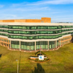 Aerial view of One Energy Place, a five-story Class A waterfront office building in Pensacola, Florida.