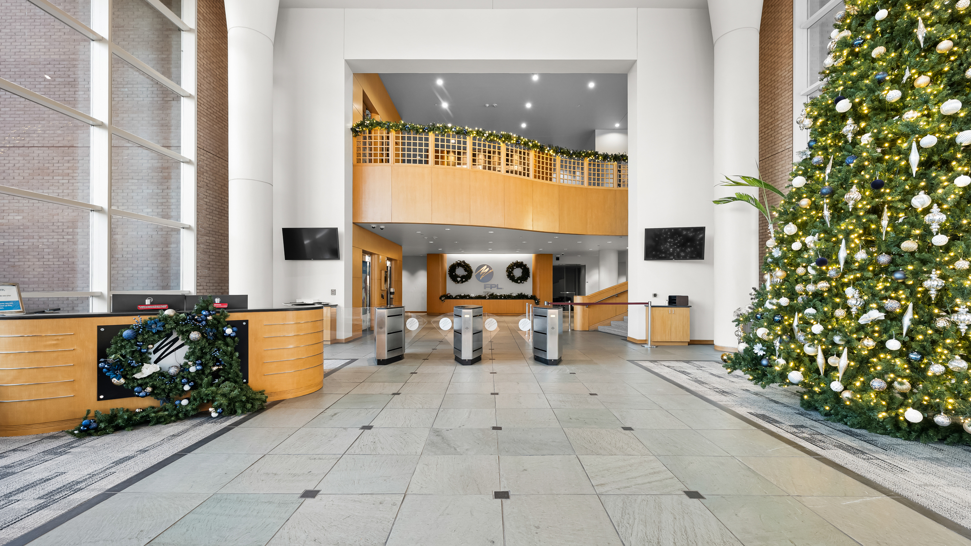 Two-story main lobby and reception area inside One Energy Place in Pensacola, Florida.